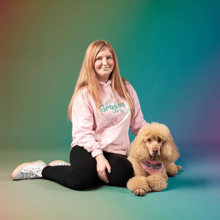 Emily, the groomer behind Grooms by Emily, with one of her poodle clients